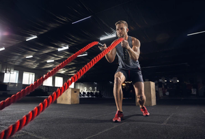 Young-healthy-man-athlete-doing-exercise-with-ropes-gym-single-male-model-practicing-hard-training-his-upper-body-concept-healthy-lifestyle-sport-fitness-bodybuilding-wellbeing_155003-27879
